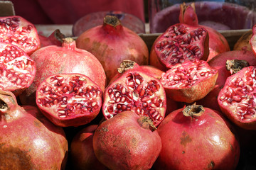 Half colorful red pomegranate pile stack one over another in food market for sale