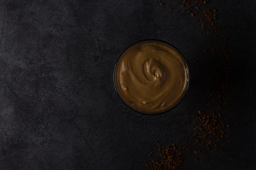 Cold dalgon coffee is a fashionable Korean drink. Dark background, view from above.