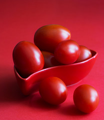 Red cherry on a red background, monochrome close-up shot