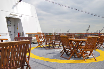Terrace or patio or balcony on outdoor deck of luxury cruiseship or cruise ship liner with wooden...