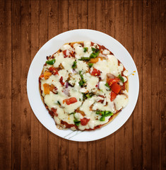Homemade Pizza with Tomato, Onion & Capsicum on White Plate - Wooden Background