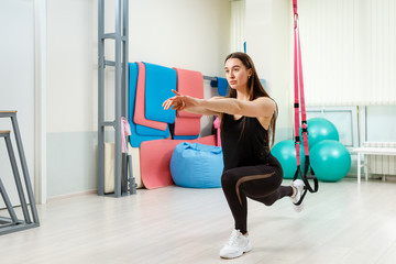 Fototapeta premium Beautiful and strong girl goes in for sports in the gym