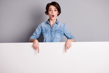 Astonished crazy point index finger white empty board copyspace impressed incredible advertisement promotion stare stupor wear style stylish trendy clothes isolated gray color background