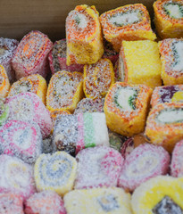 Fototapeta na wymiar Various types or many colorful assortment of Turkish delights rolls for sale