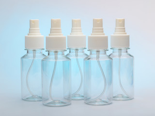 set of clear bottles with a spray for antiseptic against coronovirus covid19