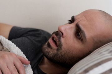 Obraz premium Caucasian bearded man wakes up after a nightmare