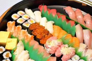Overhead view of Japanese food sushi . several rolls with tuna, salmon and shrimp. Japanese delivery sushi set at home party.