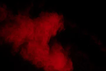 Dekokissen Red powder explosion on black background. Freeze motion of red dust particles splash. © Pattadis