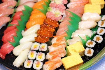 Overhead view of Japanese food sushi . several rolls with tuna, salmon and shrimp. Japanese delivery sushi set at home party.