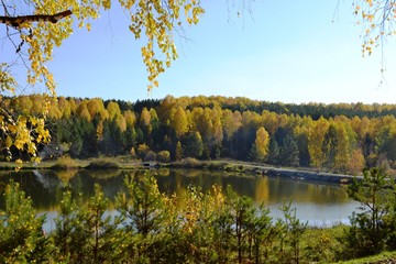 Autumn Siberian forest surrounds a pond, Kemerovo region