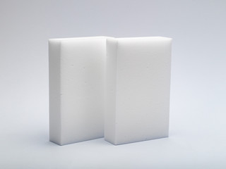 two white sponges made of a porous material for careful washing of various surfaces