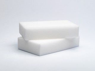 two white sponges made of a porous material for careful washing of various surfaces