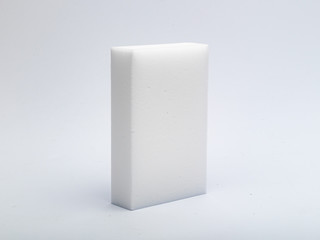 white sponge made of a porous material for careful washing of various surfaces