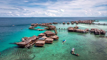 Stilt houses in the middle of the sea drone shoot - obrazy, fototapety, plakaty