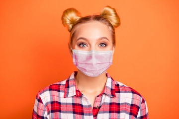 Close up photo of cute girlish charming lady feel glad candid dreamy have fashionable hairdo checked plaid shirt wear protective flu mask isolated orange background