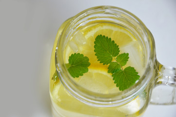 Glass of soda drink with lemon slices and mint isolated on white background. From top view. glass of lemon ice tea or detox water. health care fitness diet concept. lemonade or mojito cocktail