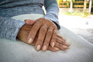 Fototapeta premium Hand of an old woman withering on his lap