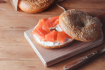 Fresh made Bagel with Salmon on old wooden table