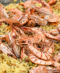 Seafood paella cooked in a large pan wok, street food festival. Mexican fiesta national day