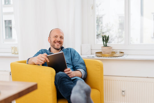 Happy relaxed middle-aged man with friendly grin