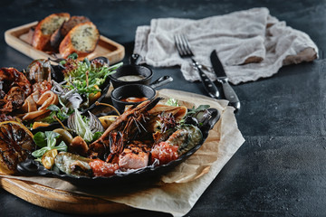 Assorted seafood, shrimp, scallops, squid, mussels. Serving plates on the table with a set of seafood. Classic italian food.