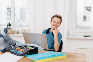Teenage boy studying at home during the lockdown
