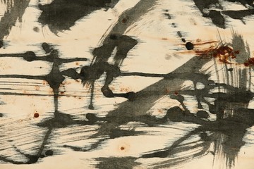 abstract grunge background, artistic painting with black paint on a light wooden background,...