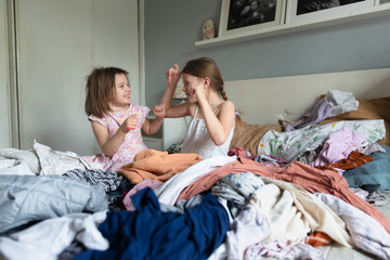 Children played and scattered clothes on the bed