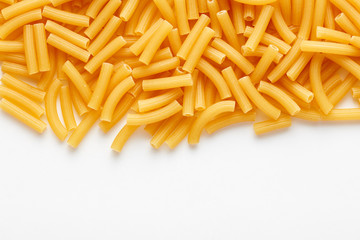 Heap of raw ditalini pasta on white background with copy space