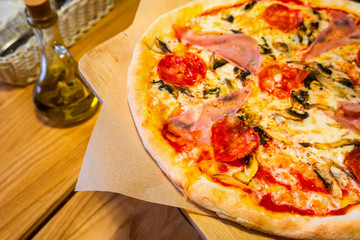 Delicious pizza with pepperoni and sausages on wooden table, top view