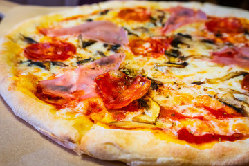 Delicious pizza with pepperoni and sausages on wooden table