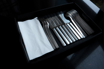 Place Setting with Knife, spoon and Fork  with tissue paper is in the black tray.