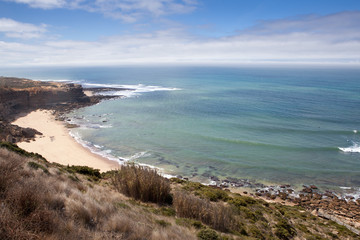 Stunning views of the north beach at the Ericeira World Surf Reserve with surfers in the ocean, Portugal