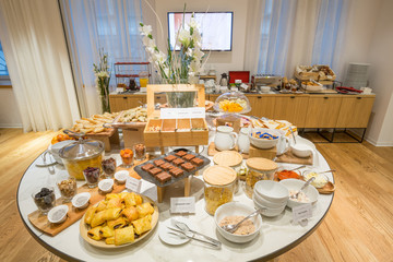 Breakfast served on round buffet table in hotel restaurant