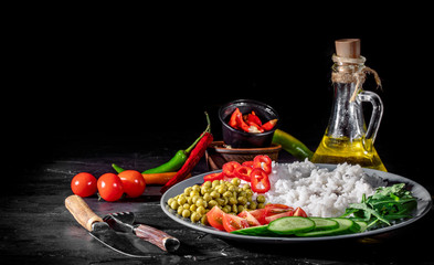 Appetizing healthy rice with vegetables on dark background. Healthy eating