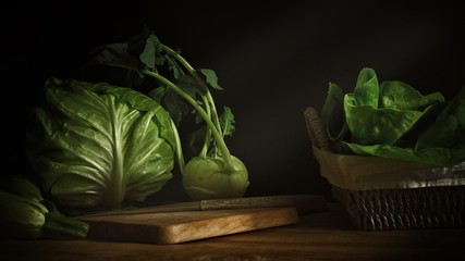 Close up of fresh green vegetables kohlrabi turnip cabbage and zucchini on wooden table and wooden chopping board in low light photography