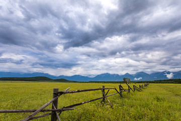 wooden fence in the valley with mountains, Arshan, Tunka valley