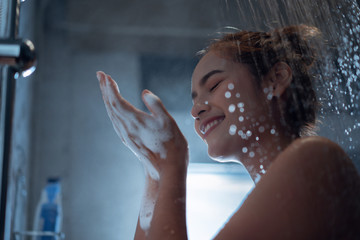 Asian woman Enjoying the shower and rubbing soap She feels relaxed