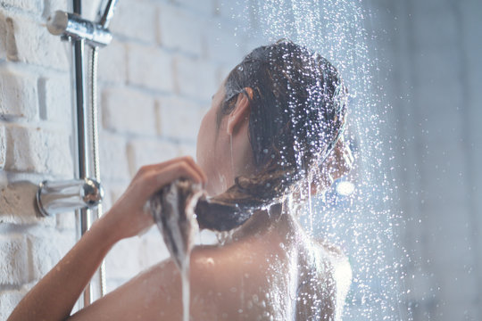 Asian woman Enjoying the shower She is washing her hair.