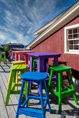 Fototapeta na wymiar Colorful Wood Stools and Tables on a Restaurant Patio