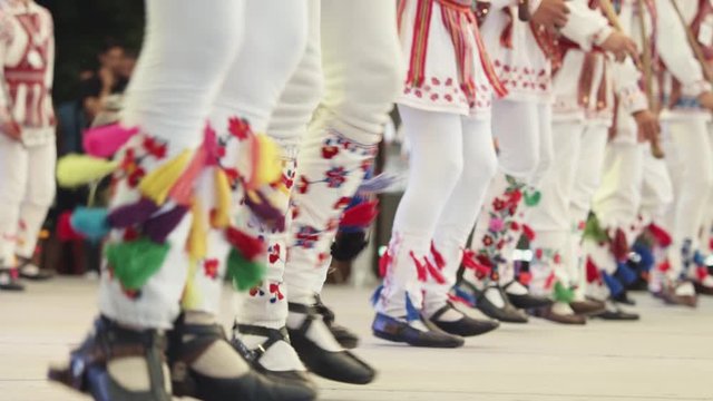 Calusari,  dansul Călușului - Romanian traditional dance.  Traditional romanian folklore dancers in traditional costumes dancing on stage in slow motion