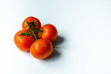 Red juicy tomatoes on a white background