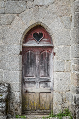 Ancient wood door at the fortified monastery of Saint-Michel des Anges at Saint-Angel, France.