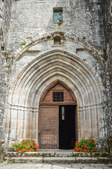 Fototapeta premium Entry door of the fortified monastery of Saint-Michel des Anges at Saint-Angel, France.