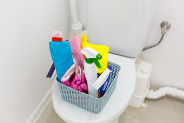 Basket with cleaning items on blurry background