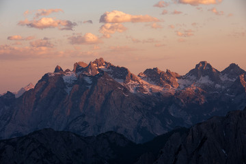 Fototapeta na wymiar Mountain landscape in the European Dolomite Alps at the Three Peaks with alpenglow during sunset, layers of mountains, South Tyrol Italy.