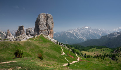Mountain peaks with hiking path and meadow of Cinque Torri in the Dolomite Alps in summer, green grass, South Tyrol Italy.