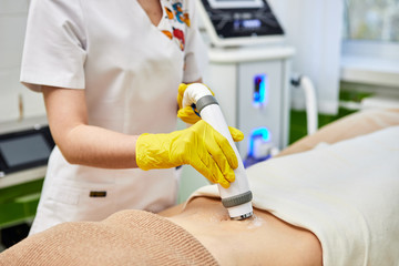 Rf skin tightening, belly. Hardware cosmetology. Ultrasound cavitation body contouring and sculpting treatment, anti-cellulite and anti-fat therapy in beauty salon.