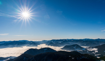 Western Tatras mountains snowy with fog in the valley in winter, Slovakia Velky Choc 12.1.2020