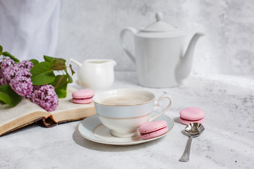 good morning card. a blooming branch of lilac, a Cup of coffee, macaroni, an old book, a teapot